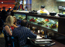 Guests enjoy drinks at Okura Restaurant's sushi bar in La Quinta!