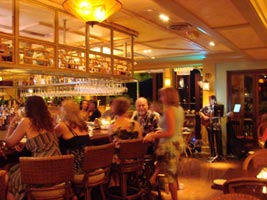 Friends gather for drinks at the Bungalow Bar at Tommy Bahama's on the Big Island