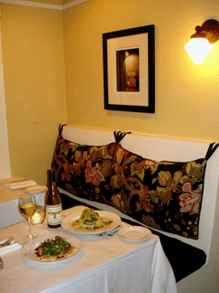 The main dining room with fireplace, and the cozy wine bar at Black Cat Bistro in Cambria.
