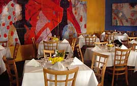 Mozaic murals and wall hangings provide color and texture to the second flloor private room.